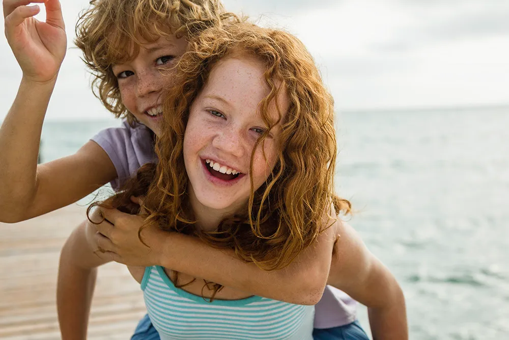 spain-girl-giving-piggy-ride-to-boy-smiling-2024-09-23-04-04-44-utc Surgical Orthodontics
